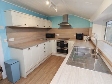 A kitchen with cabinets and appliances at Braeburn in Bamburgh