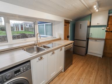 A kitchen with appliances and a sink at Braeburn in Bamburgh