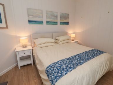 A bedroom with a double bed and nightstands at Braeburn in Bamburgh