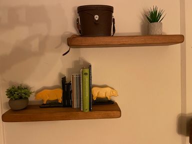 Shelves with books and decor items at Braeburn in Bamburgh