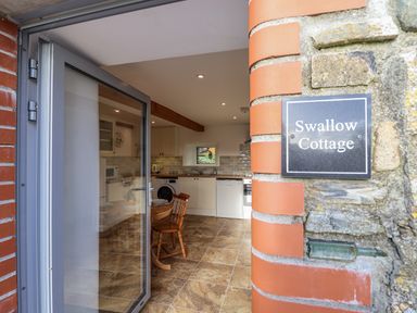 A kitchen with a table and chairs at Swallow Cottage Bullhornstone near South Brent