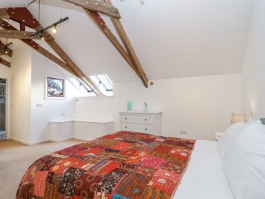 A bedroom with a bed and dresser at Swallow Cottage Bullhornstone near South Brent
