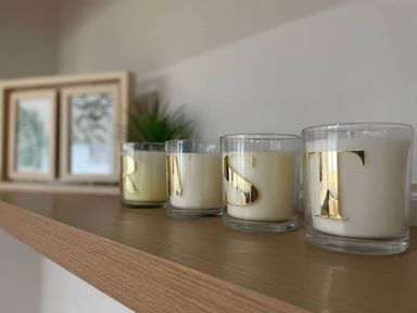 A shelf with candles and framed pictures at Aspen Apartment in Llanrwst
