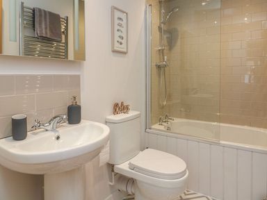 A bathroom with a sink and shower at The Old Workshop in 