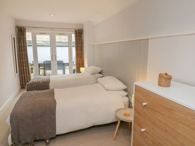 A bedroom with two beds and a dresser at The Old Workshop in 