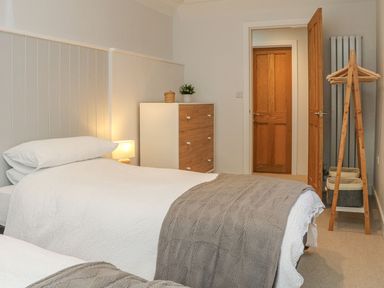 A bedroom with two beds and a dresser at The Old Workshop in 