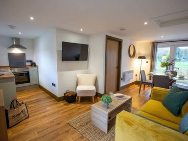 A living room with a sofa and coffee table at Silver Birch Cottage in Llanrwst