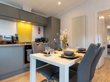 A kitchen with a dining table and chairs at The Falls in Leyburn