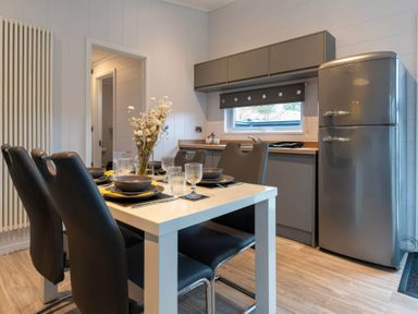 A kitchen with a dining table and chairs at The Falls in Leyburn