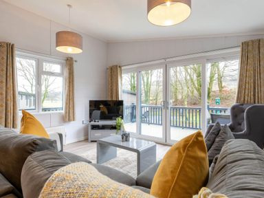 A living room with a sofa and television at The Falls Leyburn