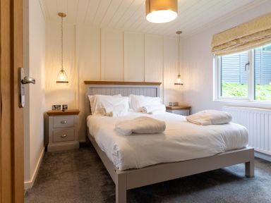 A bedroom with a bed and nightstand at Wensleydale (Pet) Aysgarth