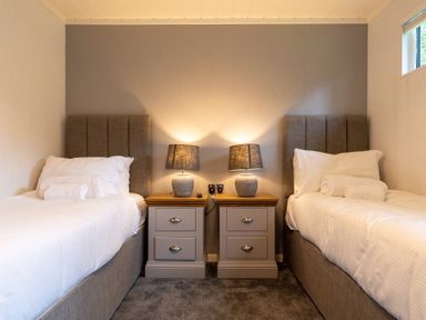 A bedroom with twin beds and nightstands at Wensleydale (Pet) Aysgarth