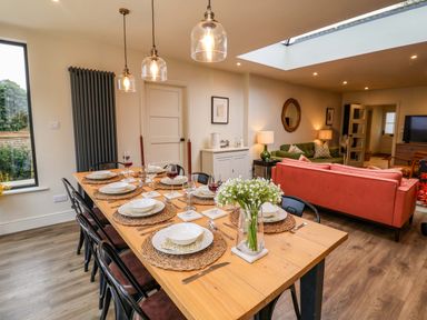 A dining room with a table set for dinner at Fairview in Darsham