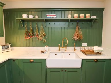 A kitchen with a sink, faucet, and drying rack at Fairview in Darsham