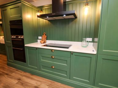 A kitchen with green cabinets and a stove at Fairview in Darsham
