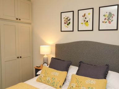 A bedroom with a bed and wardrobe at Fairview in Darsham