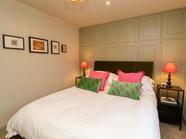 A bedroom with a bed and wall art at Fairview in Darsham