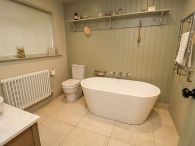 A bathroom with a bathtub and toilet at Fairview in Darsham