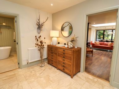 A hallway with a buffet table and a mirror at Fairview in Darsham