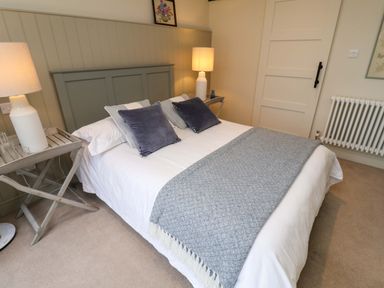 A bedroom with a bed and bedside table at Fairview in Darsham