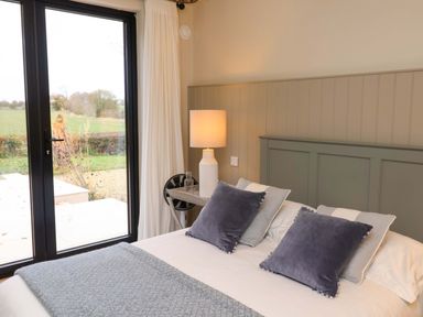 A bedroom with a bed and pillows at Fairview in Darsham