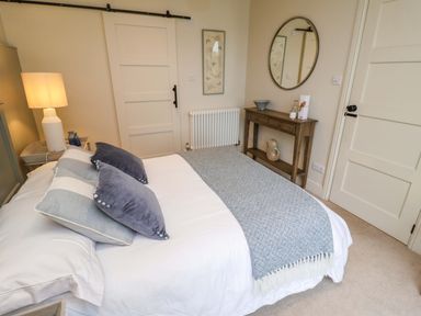 A bedroom with a bed and decorative items at Fairview in Darsham