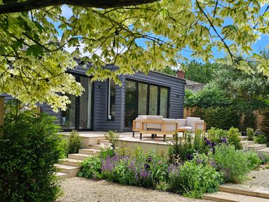 A house with outdoor seating and plants in the garden at Fairview in Darsham