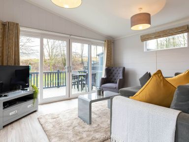 A living room with a television and sofa at The Falls (Pet) Leyburn