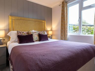 A bedroom with a bed and bedside lamps at The Falls (Pet) Leyburn