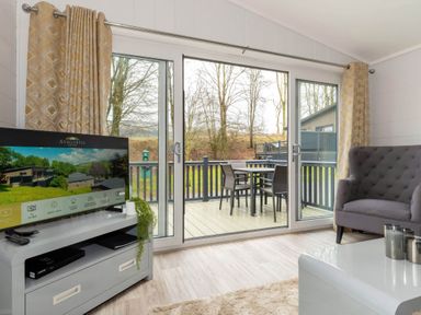 A living room with a television and sofa at The Falls (Pet) Leyburn