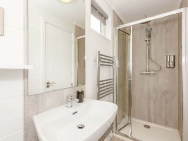A bathroom with a shower and sink at The Falls (Pet) in Leyburn
