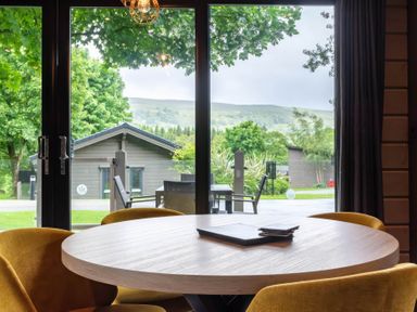 A dining room with a round table and chairs at Middleham Leyburn