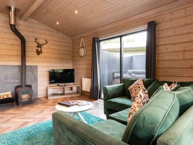 A living room with a sofa and television at Middleham in Leyburn