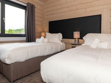 A bedroom with two beds and a lamp at Middleham (Pet) Leyburn