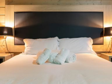 A bedroom with a bed and towels at Middleham (Pet) in Leyburn