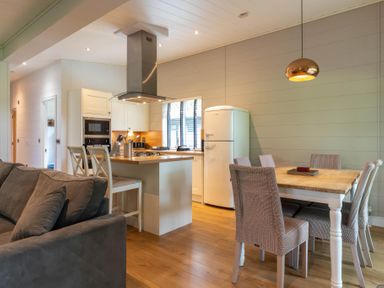 A kitchen with a dining area and refrigerator at Bainbridge (Pet) Leyburn