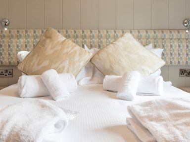A bedroom with pillows and towels on the bed at Bainbridge (Pet) Leyburn
