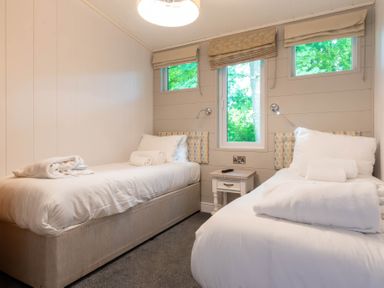 A bedroom with two beds and a bedside table at Bainbridge (Pet) in Leyburn