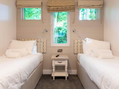 A bedroom with two beds and a window at Bainbridge (Pet) Leyburn