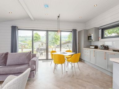 A living room with a sofa and dining table at Leyburn Leyburn