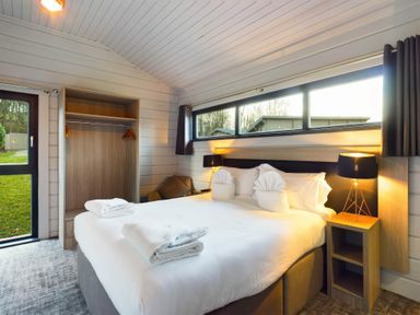 A bedroom with a bed and wardrobe at Leyburn