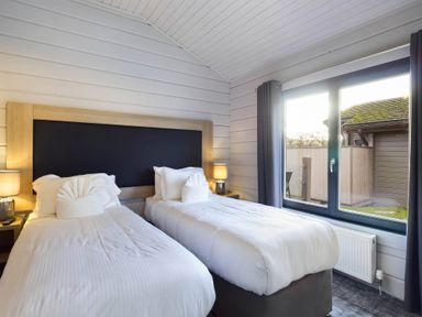 A bedroom with two beds and a window at Leyburn Leyburn