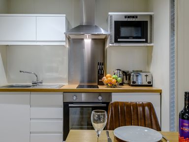 A kitchen with modern appliances and utensils at Tennyson Spa in Louth