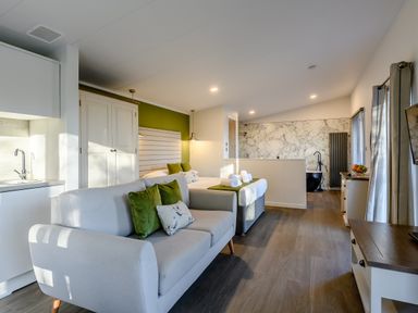A bedroom with a kitchenette and a bed at Somersby Spa (Pet) Louth