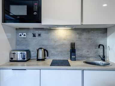 A kitchen countertop with appliances and a sink at Somersby Spa (Pet) in Louth