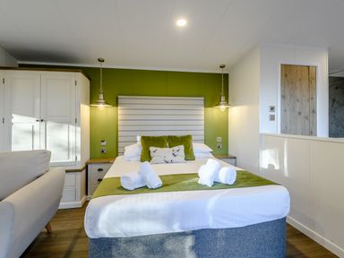 A bedroom with a bed and sofa at Somersby Spa (Pet) Louth