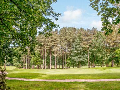 A view of a golf course surrounded by trees at Somersby Spa (Pet) Louth