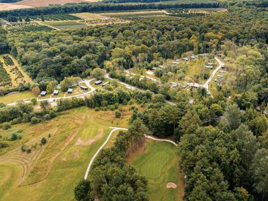 An outdoor area with cabins and a golf course at Tennyson Spa (Pet) Louth