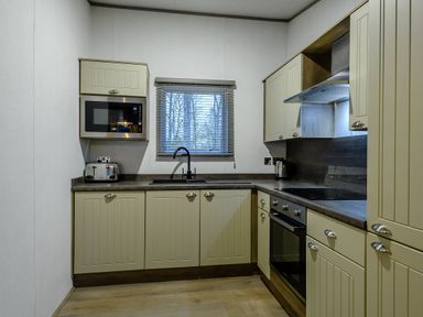 A kitchen with appliances and cabinets at Anderby Spa (Pet) Louth