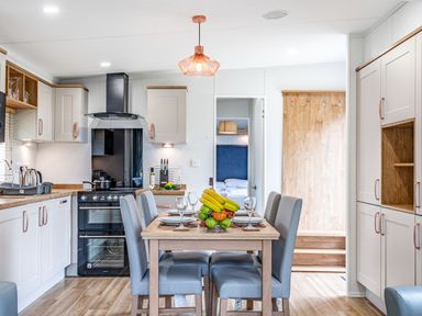 A kitchen with a dining table and chairs at Caistor Spa in Louth